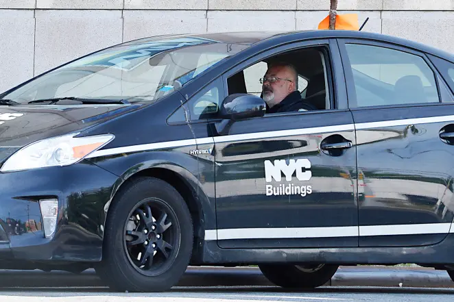 Building inspector holding a clipboard on a construction site, overseeing quality control.